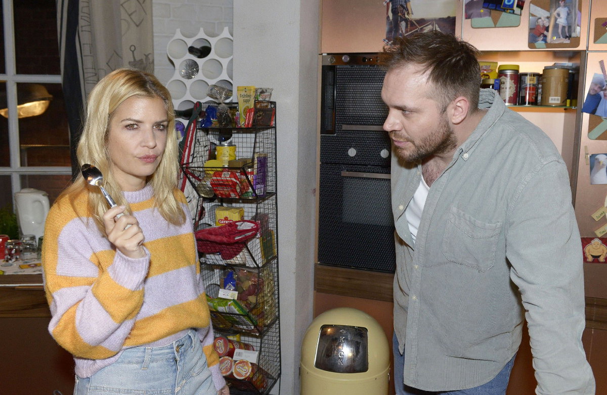 Sarah steht bei GZSZ mit Löffel in der Hand in der Küche, Erik schaut sie an
