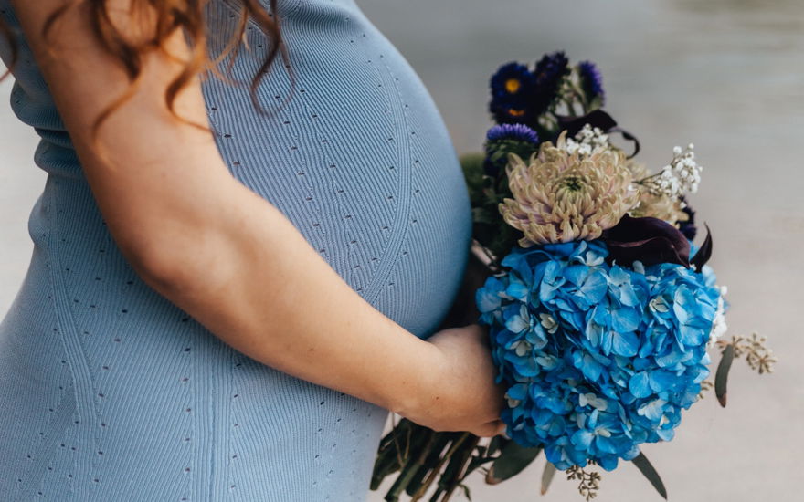 schwangere Frau mit Blumenstrauss