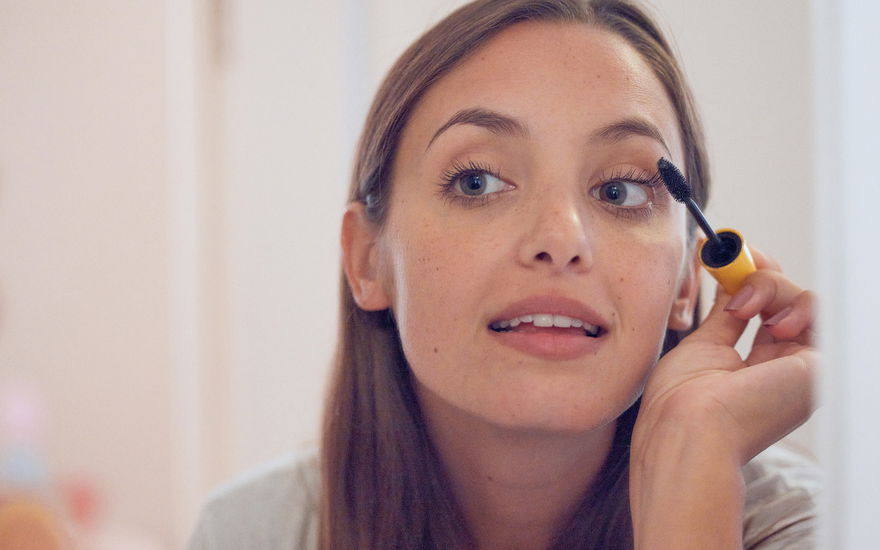 Frau benutzt Mascara für sensible Augen