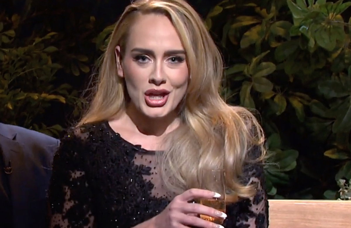 Adele spricht mit Drink in der Hand