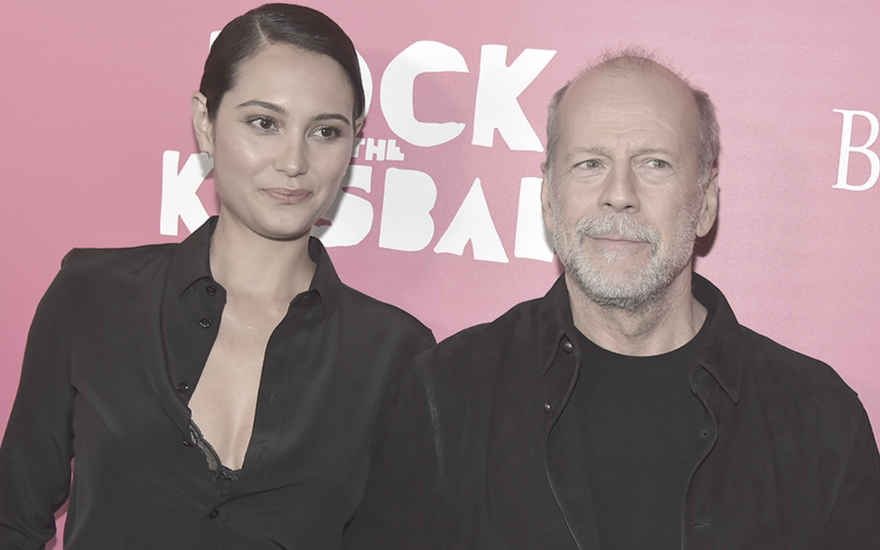 Emma Heming-Willis und Bruce Willis posieren vor einer pinken Wand