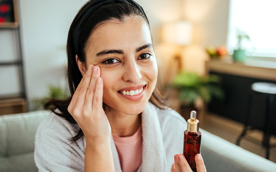 Frau pflegt Haut mit Serum