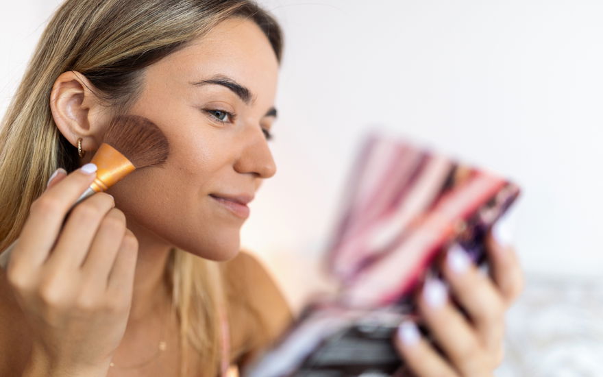Frau beim Bronzer auftragen