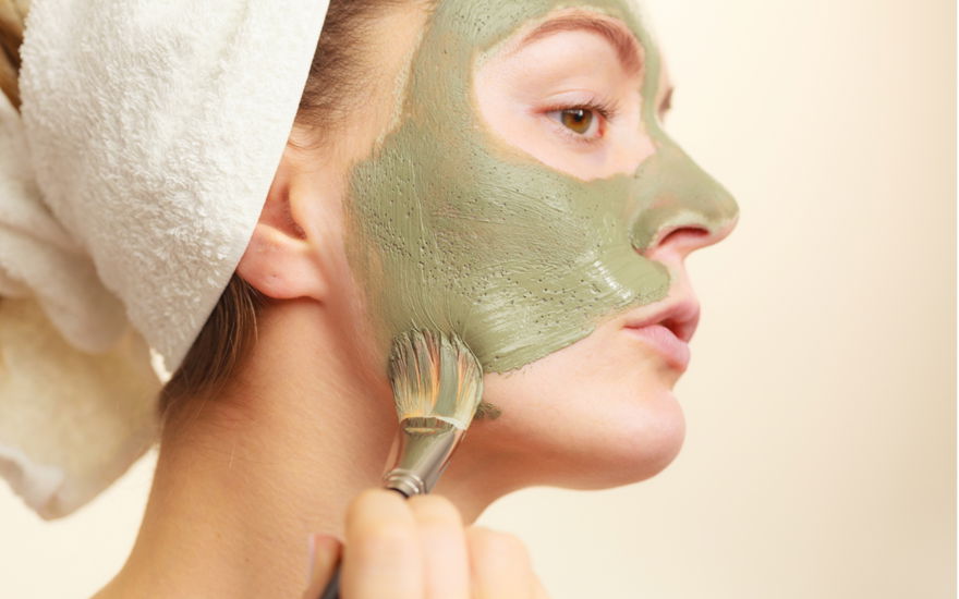Frau trägt Gesichtsmaske auf