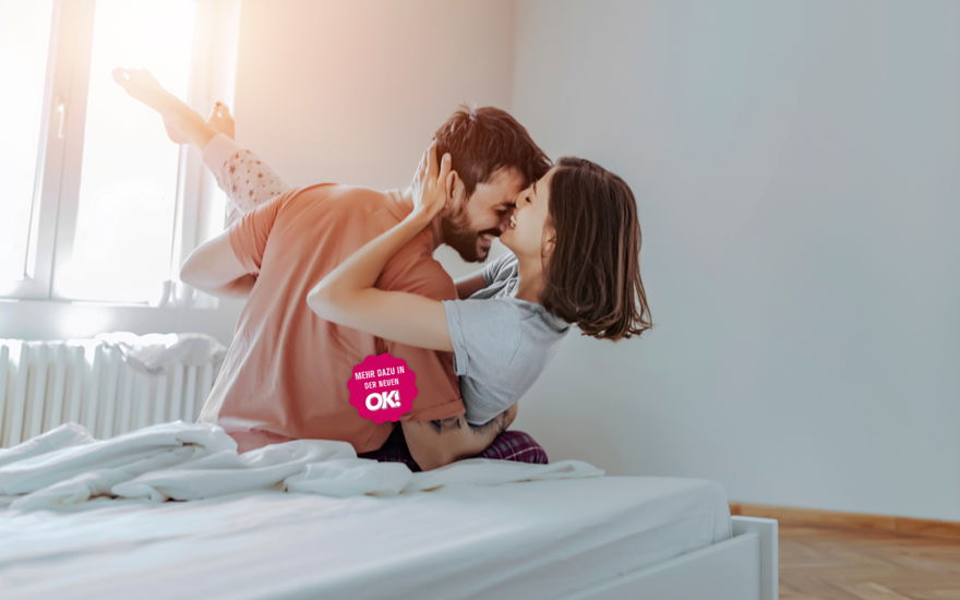 Paar küsst auf Bett