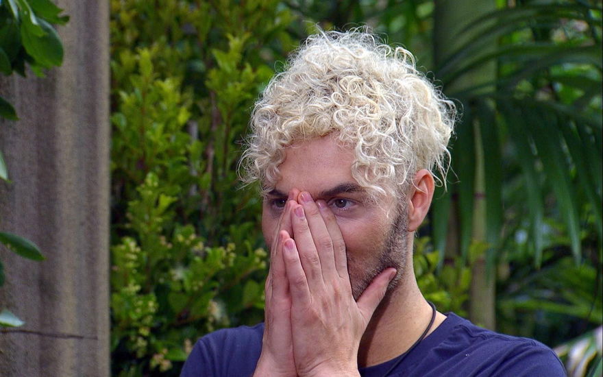 Sam Dylan guckt im Dschungelcamp mit Händen vor Gesicht geschockt