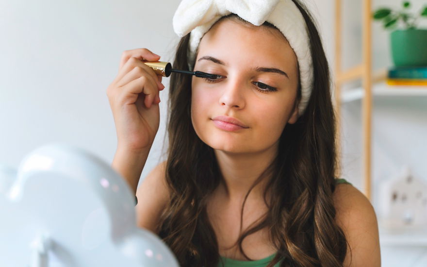 Frau tuscht Wimpern an