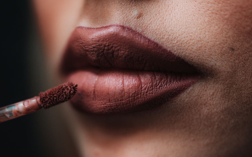 Frau trägt matte Lippenfarbe auf